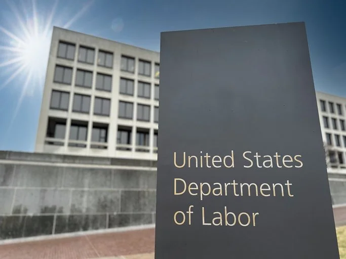 Sign that says Department of Labor in front of a building.