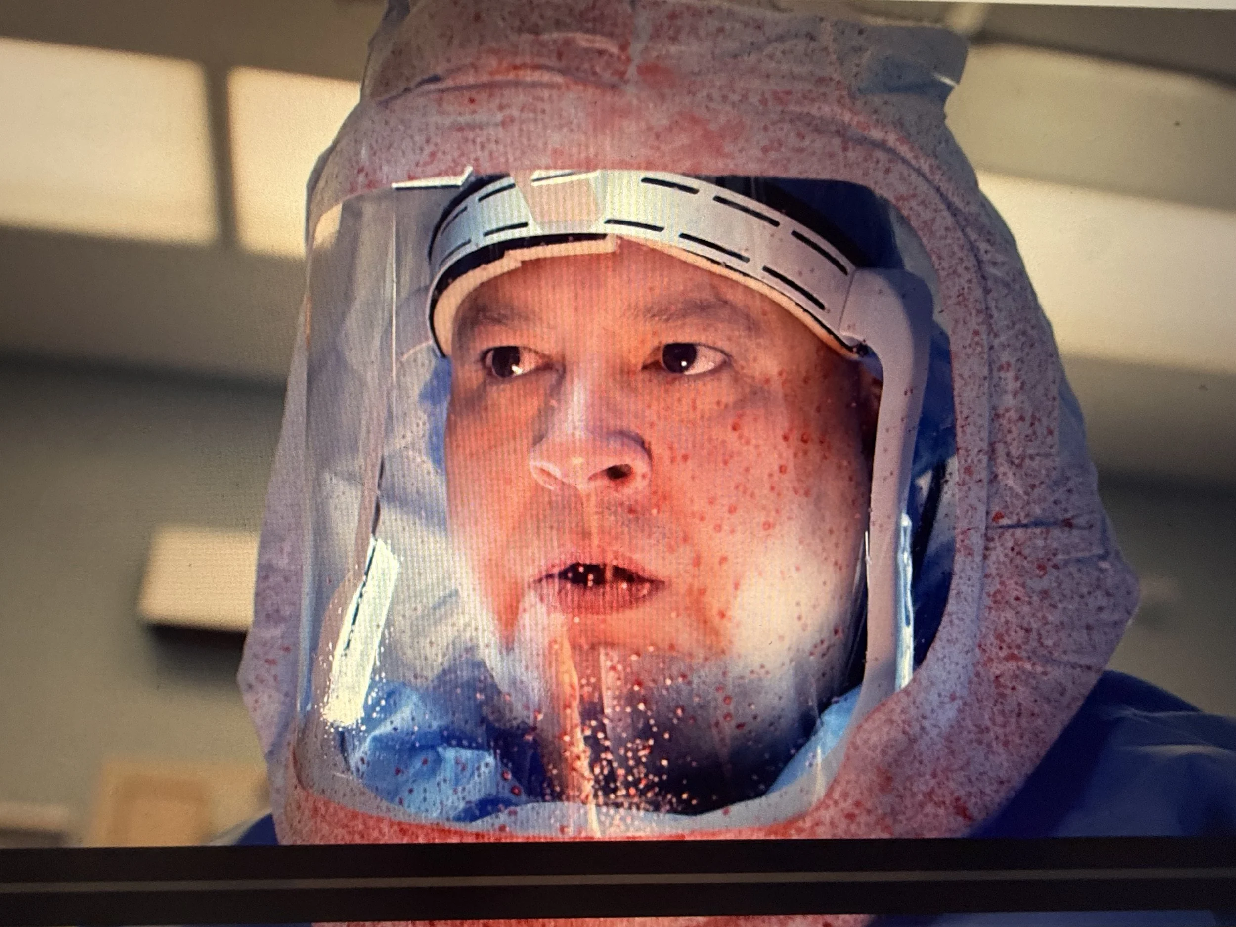 A blood-splattered shield during a tracheostomy surgery.