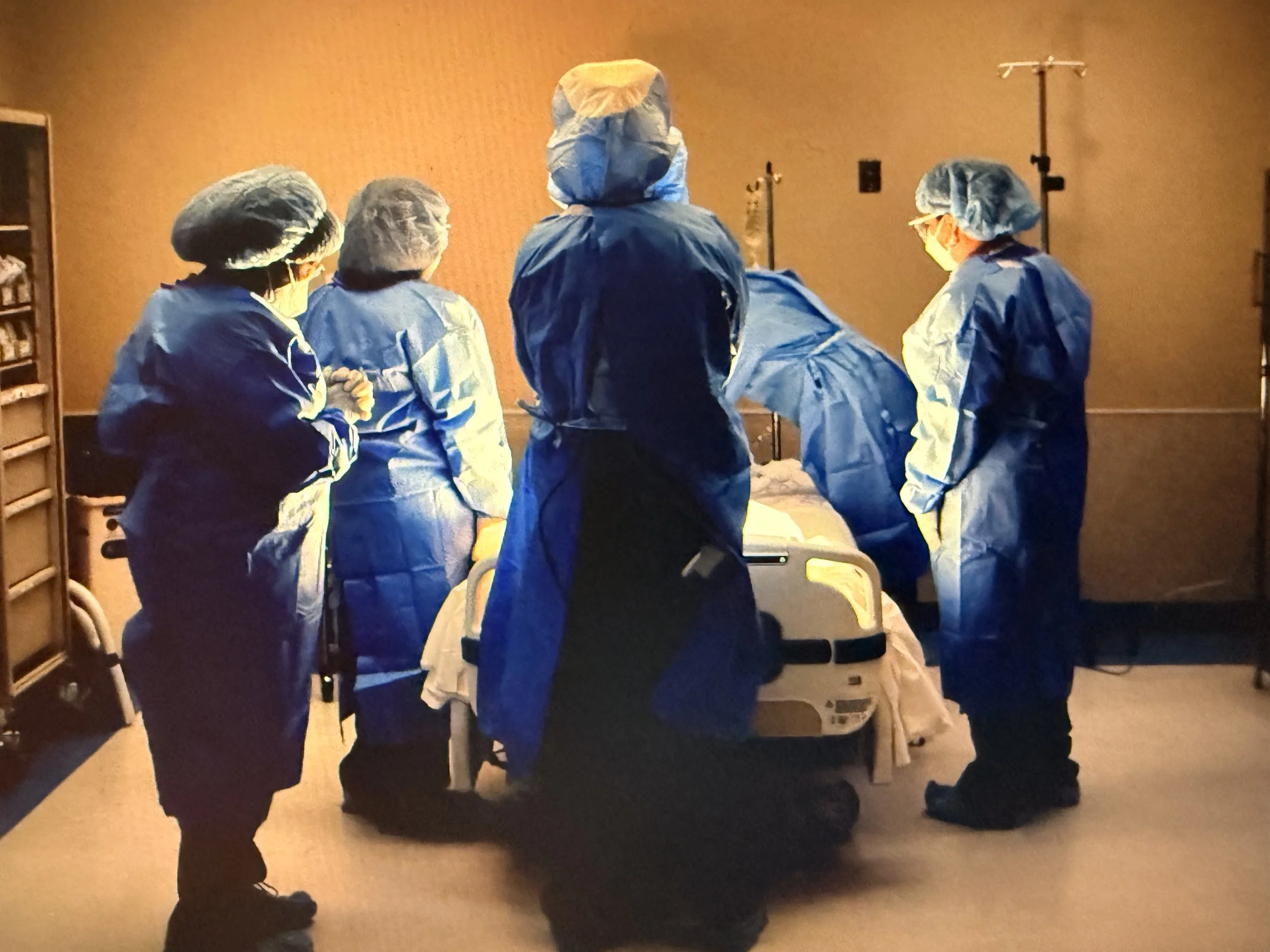 Room 4913 Denise Sprague - COVID-19 RN looks on.