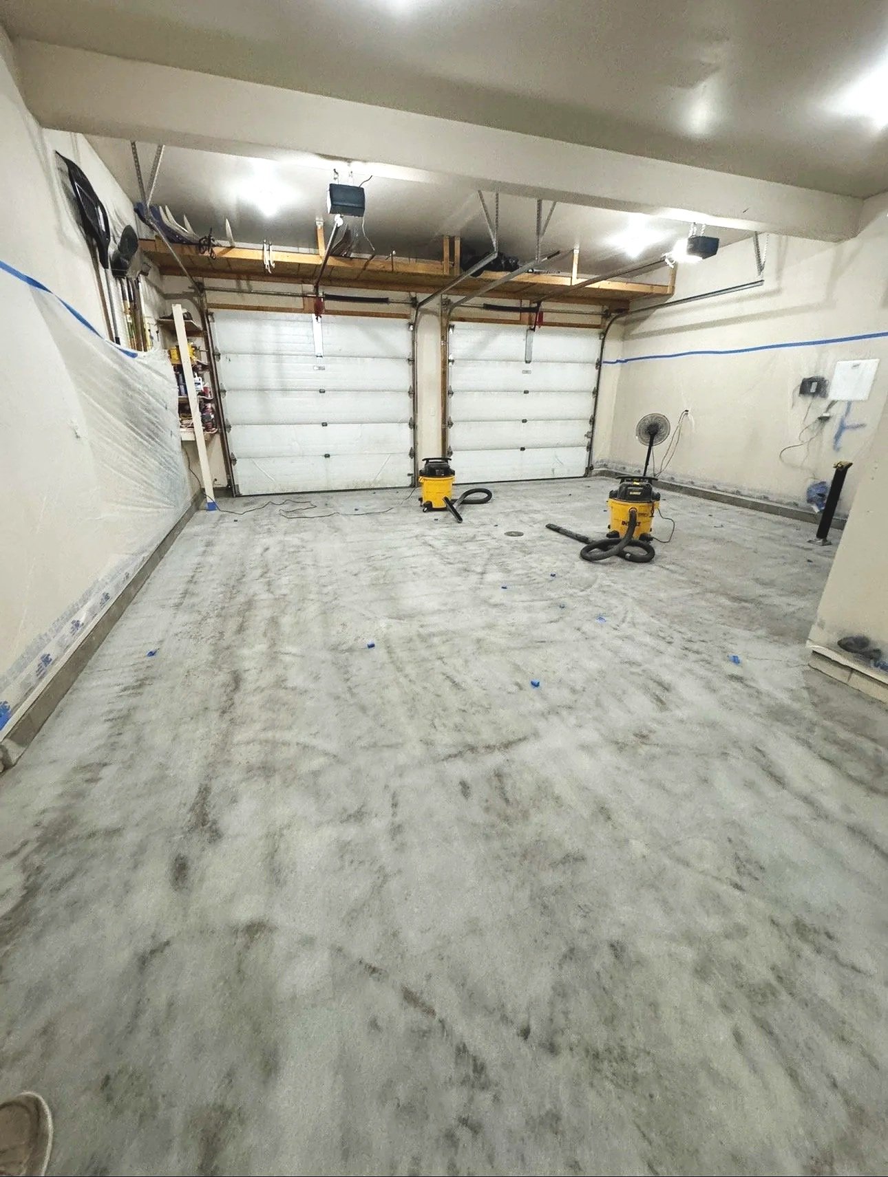 Epoxy floor preparation on garage. Garage floor repair, cracks, stains. Shop and hangar floor coatings.