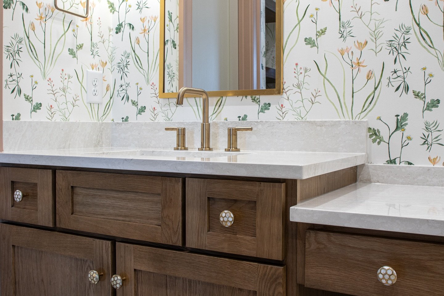 This sweet bathroom came together with the homeowner&rsquo;s choices&mdash;from the floral wallpaper to the honeycomb pulls and warm wood vanity. The mix feels fresh, fun, and perfect for their daughter&rsquo;s space.

Sometimes it&rsquo;s the little