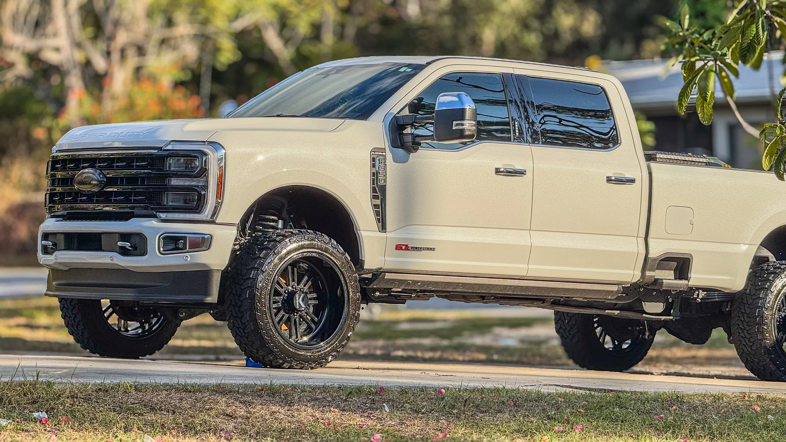 Clean pearl white truck in driveway after professional mobile detail