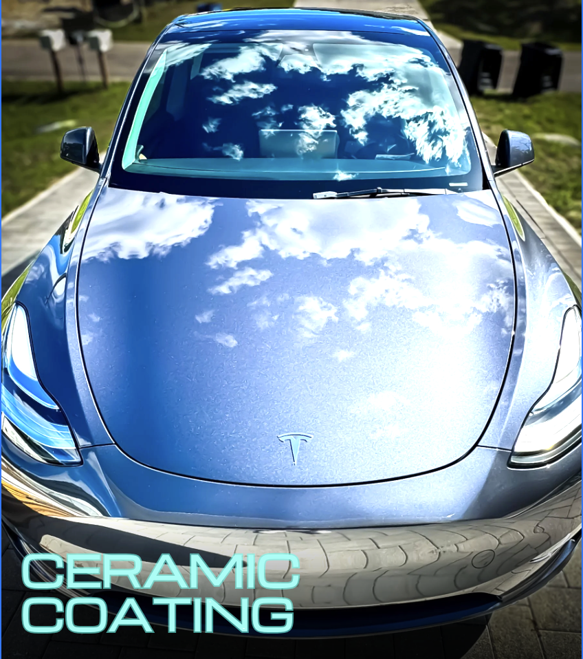 Silver Tesla 3 with mirror like reflection on hood reflecting the sky after a ceramic coating