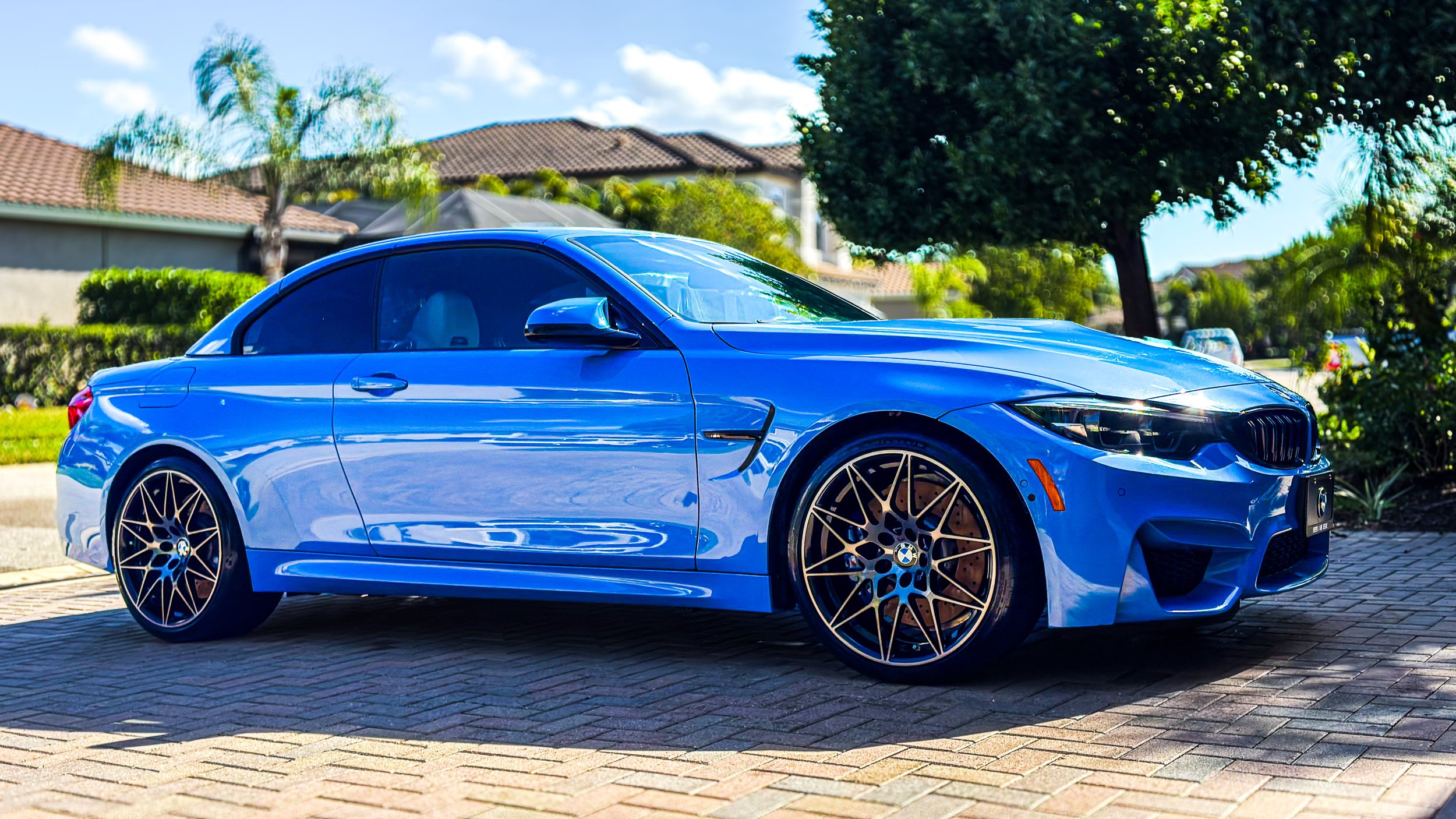 Glossy blue BMW coupe freshly detailed by Clean Always Flawless Detail in Fort Myers, Florida