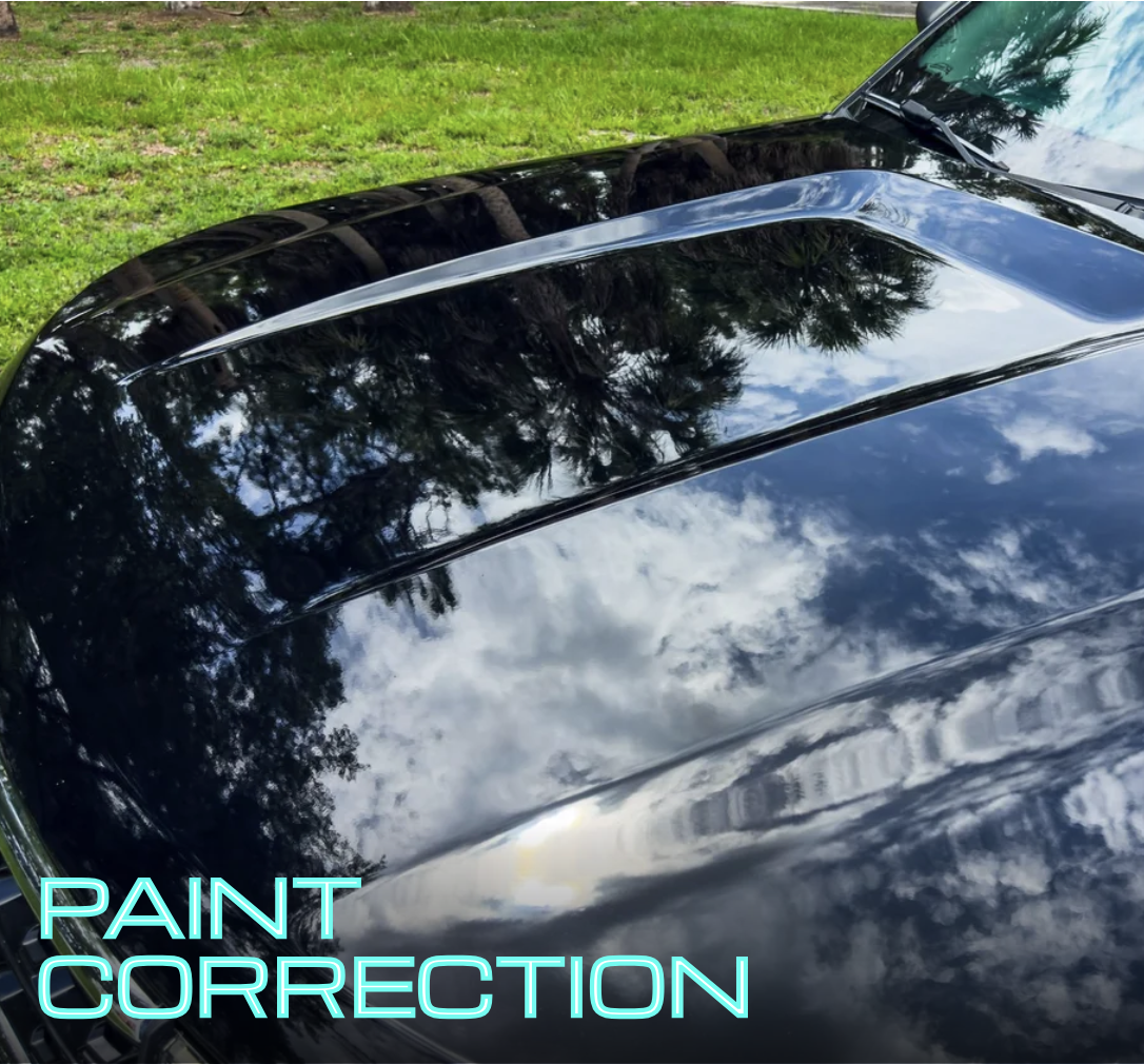 Hood of black Ford explorer showing flawless paint after a paint correction