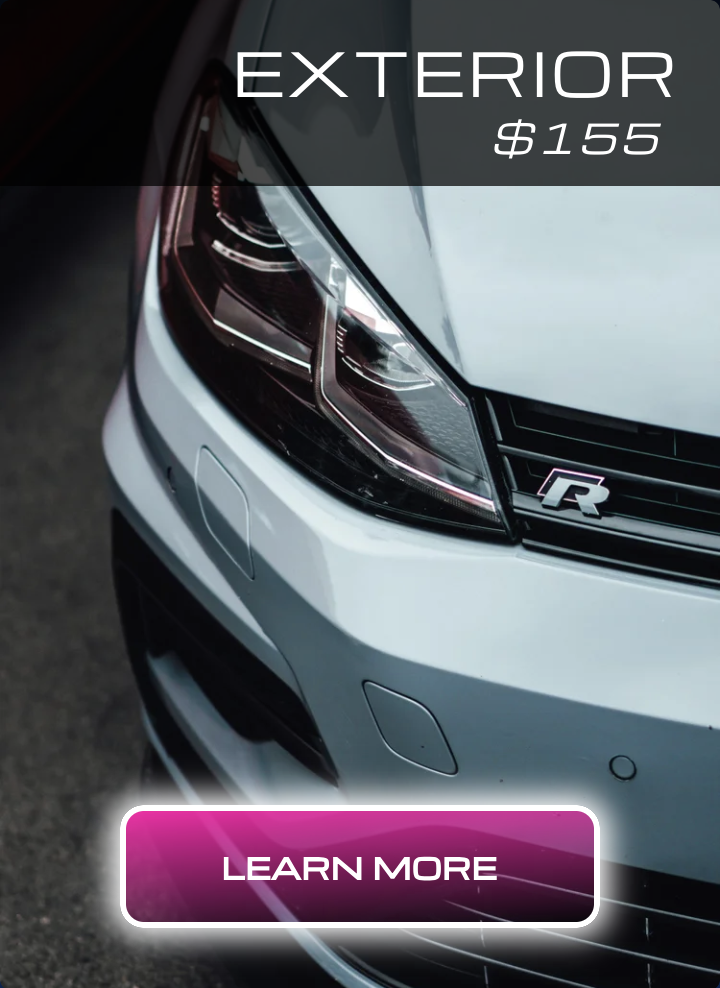 Close-up of a silver car's front exterior, showing headlight and grille with an 'R' emblem, and a black banner indicating $155 for exterior detail.