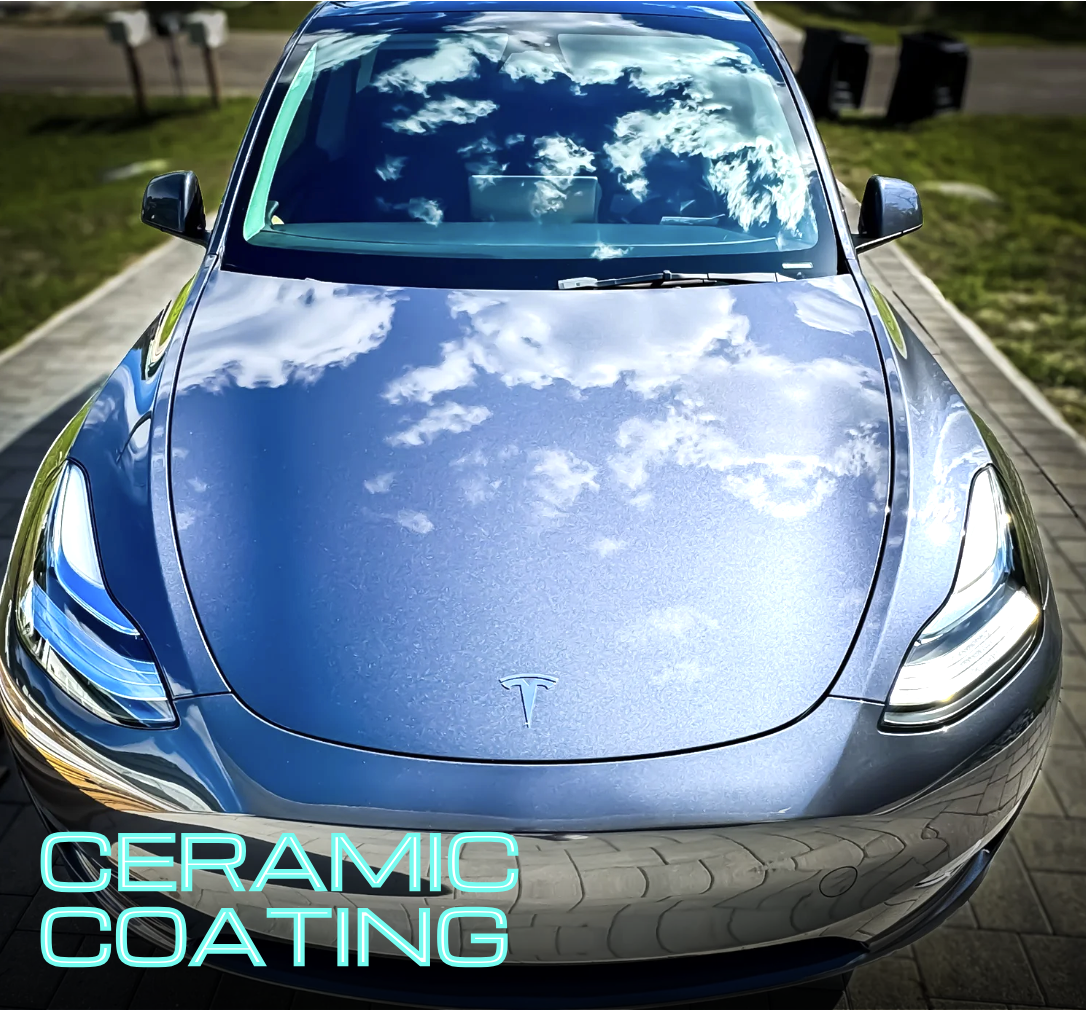 Silver Tesla 3 with mirror like reflection on hood reflecting the sky after a ceramic coating