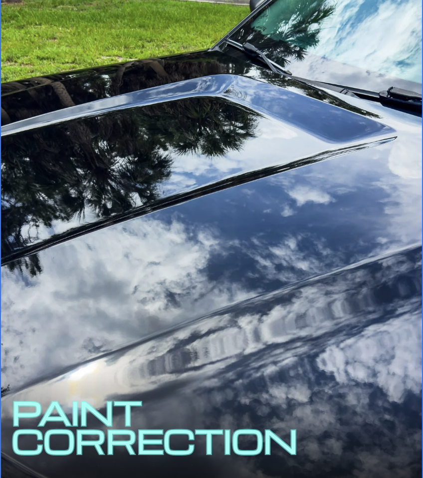 Hood of black Ford explorer showing flawless paint after a paint correction