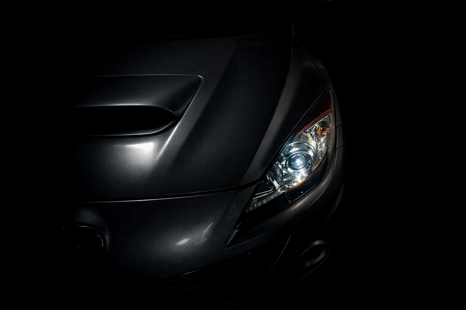 Dark, glossy Mazdaspeed3 highlighting flawless paint correction and premium mobile detailing results in Fort Myers, FL