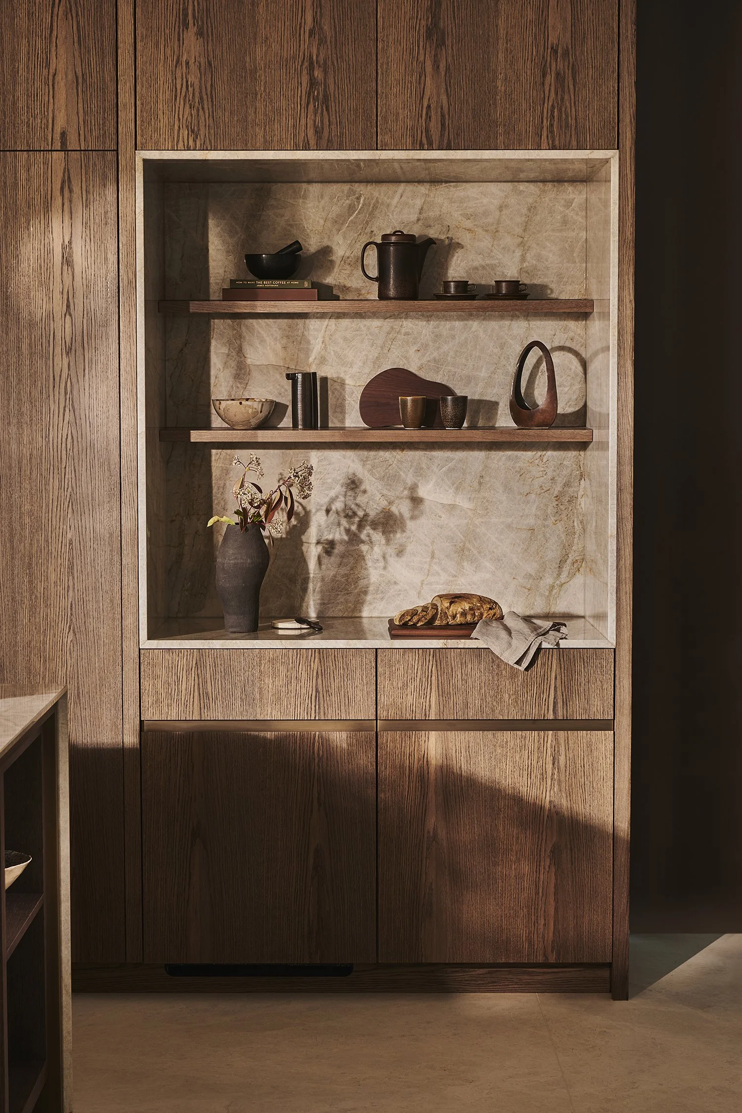 Wooden display cabinet with shelves holding decorative items and dishes.