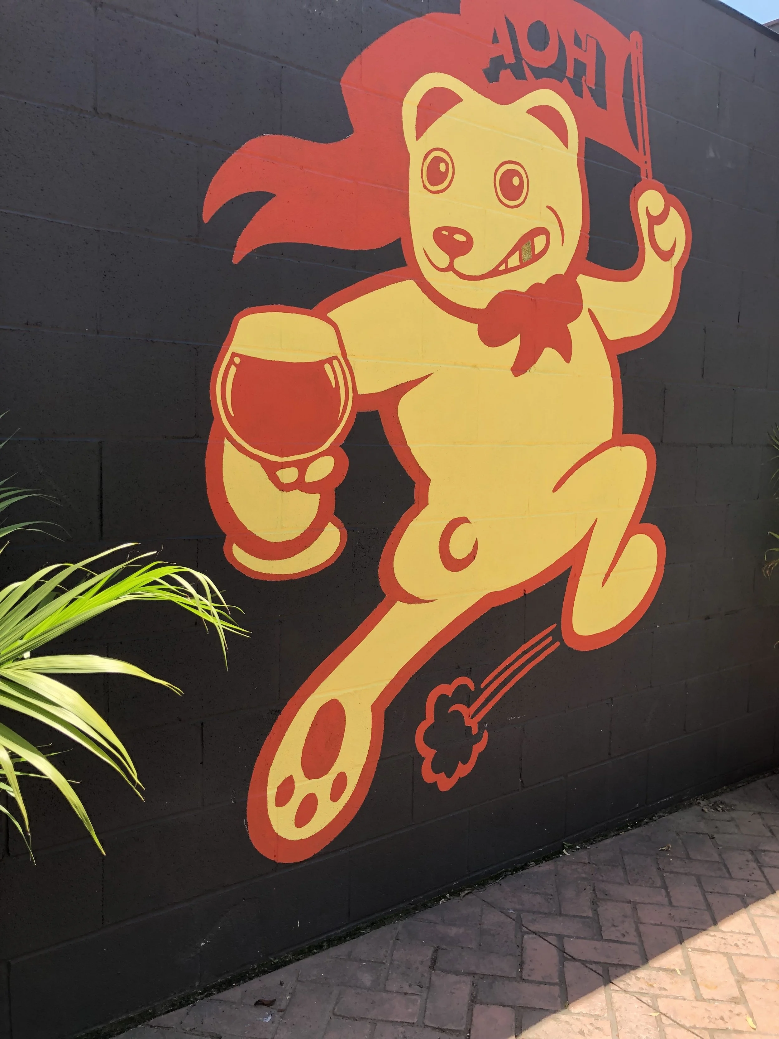 Exterior mural of Bryan the Bear on back patio of AOH