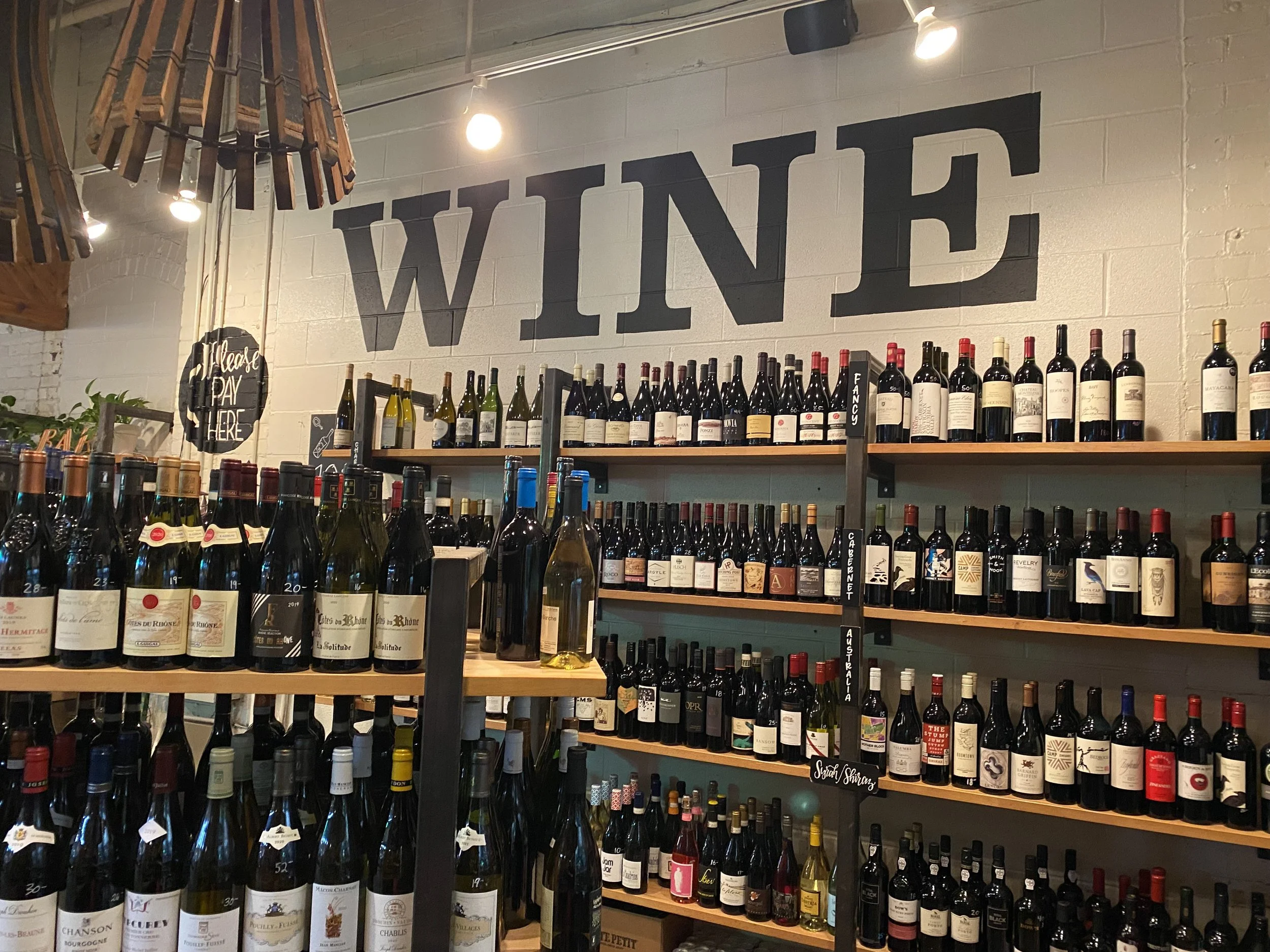 Hand painted 'Wine' header in bottle shop