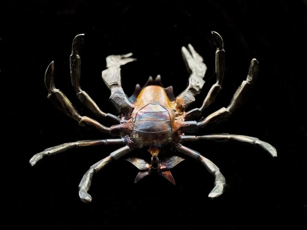 kelp crab sculpture on its back showing chiselled metalwork details of west coast creature
