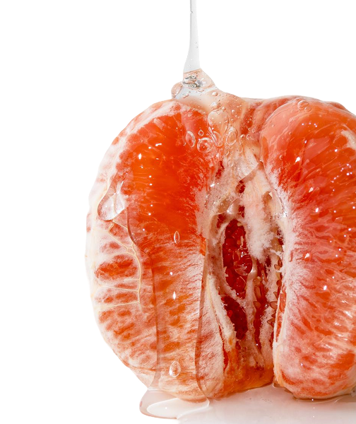 Close-up of a peeled orange with water droplets.