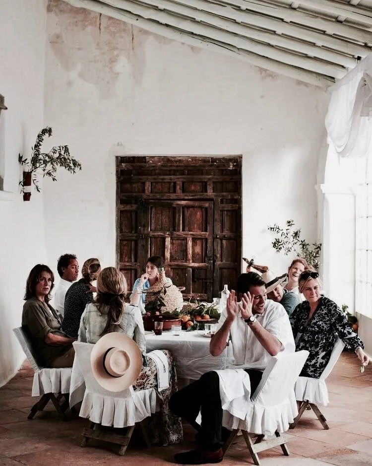 A long table dinner among friends in a rustic farmhouse