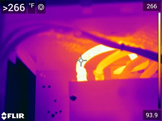 Infrared image showing hot electrical wires and components in a panel or wiring system with high temperatures above 266°F. Thermograpics. Thermograpy.  Unseen electrical problems. Hot wire. Hot contacts. Resistance at termination. Loose terminations.