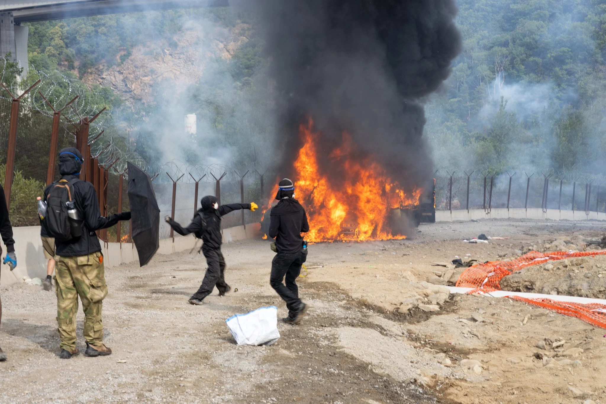 Chiomonte, Italy – July 25, 2026: No Tav protest, Black Bloc in front of the Carabinieri vans on fire at the Chiomonte construction site