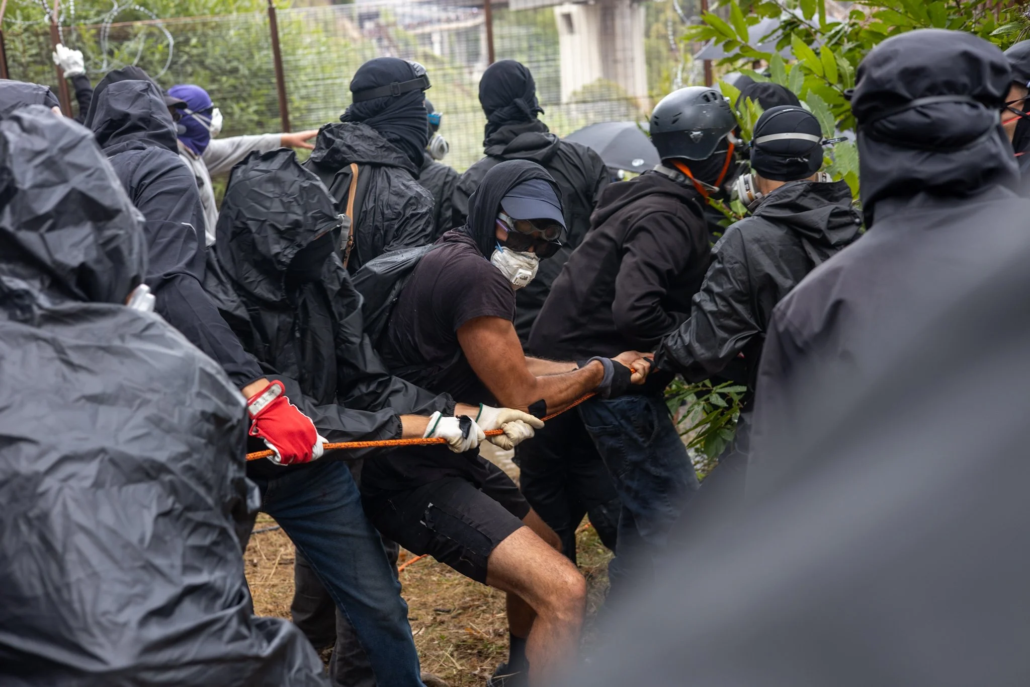 Chiomonte, Italy – July 25, 2026: No Tav protest: Black Bloc removes barbed wire from the entry of the construction site