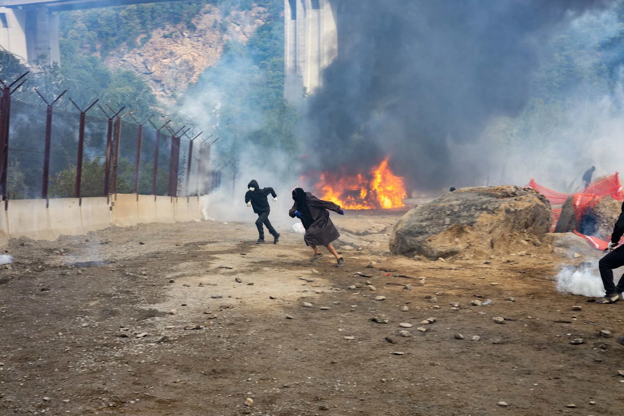 Chiomonte, Italy – July 25, 2026: No Tav protest, Black Bloc in front of the Carabinieri vans on fire at the Chiomonte construction site