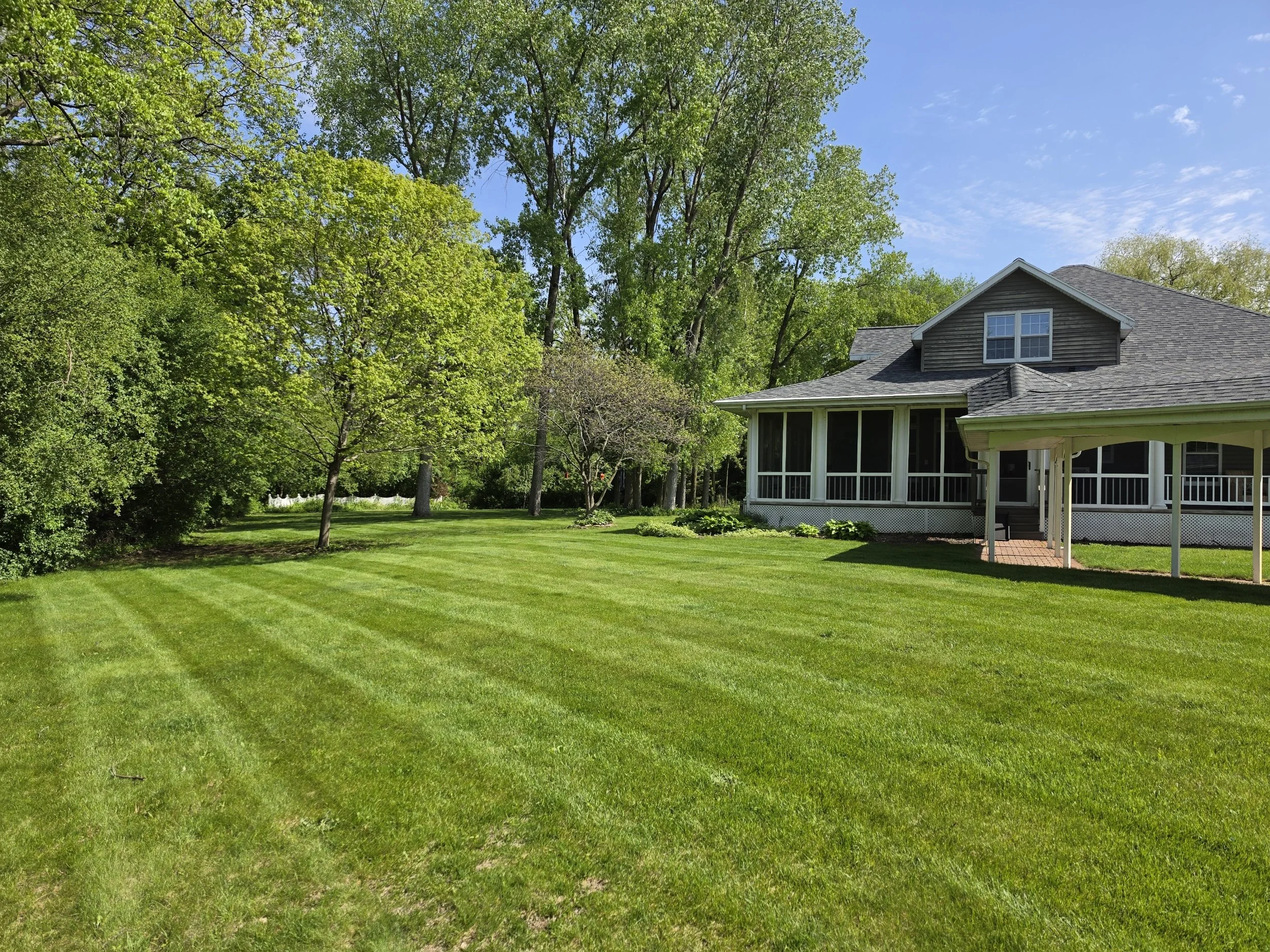 Freshly mowed green lawn with professional striping by Davis Dreamscapes in Oshkosh, WI.