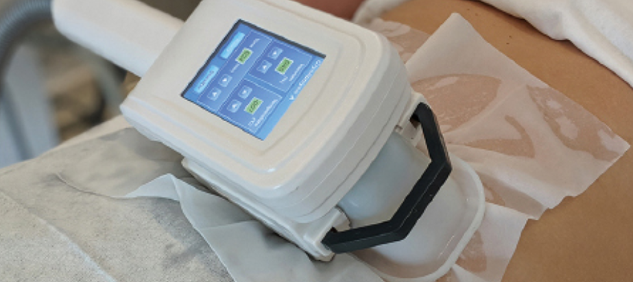 A medical device with a touchscreen screen is placed on a patient's arm during a procedure.