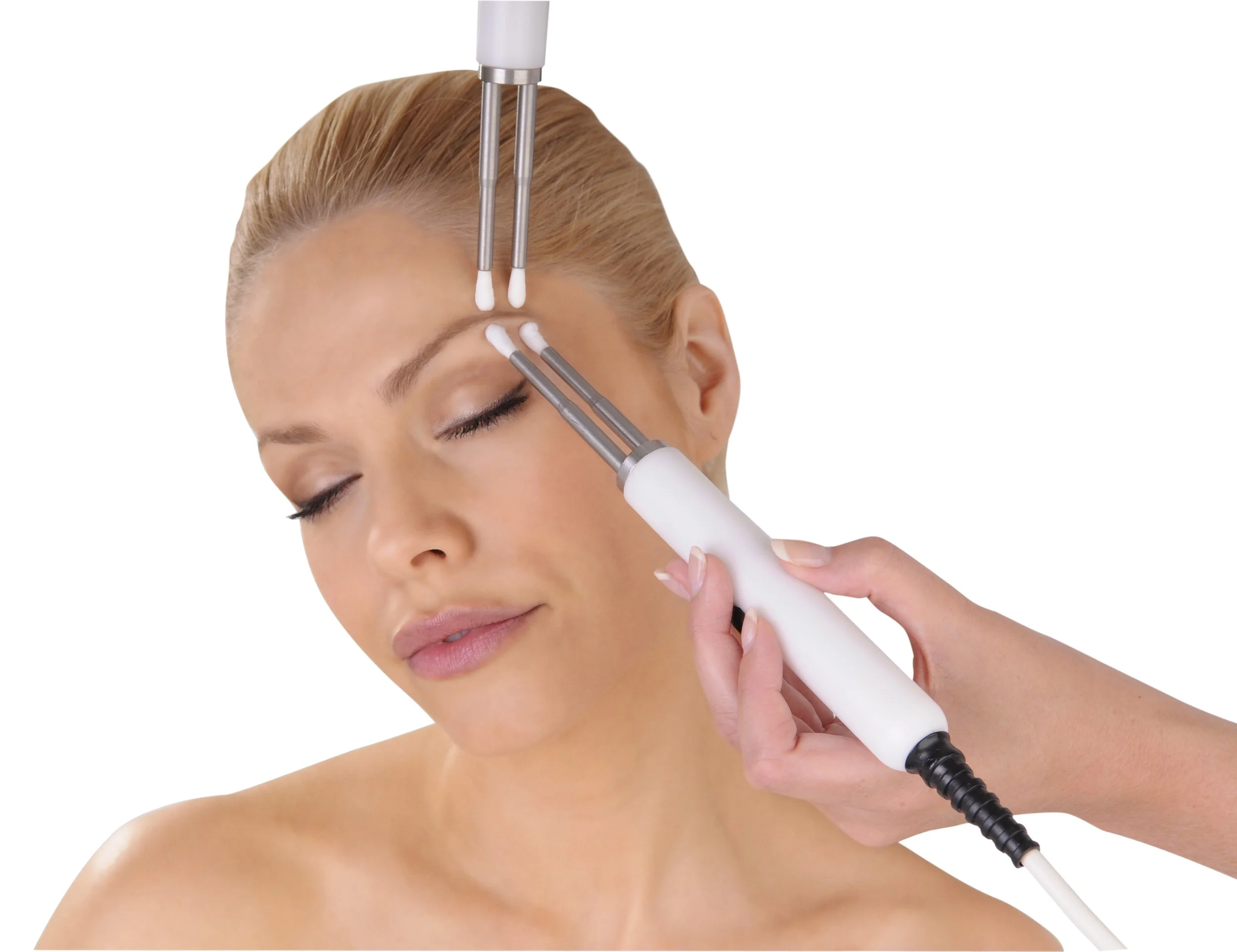 A woman receiving a facial treatment with a device that uses multiple probes on her face, her eyes closed, and she appears relaxed.