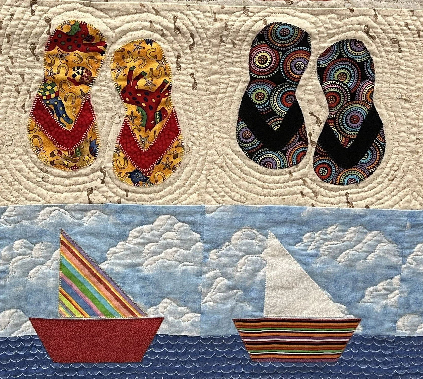 Patchwork quilt featuring flip-flops and sailboats.