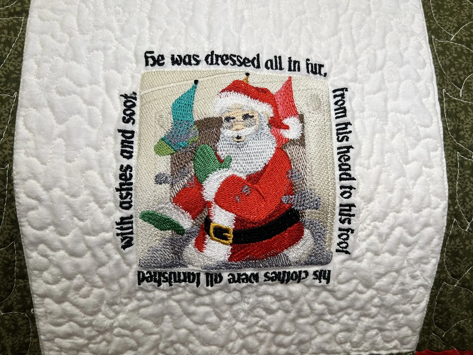 An embroidered holiday-themed patch depicting Santa Claus.