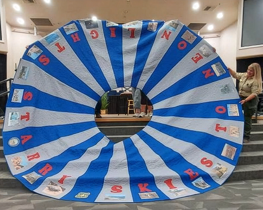 The phrase “Starry Skies to Neon Lights” appears across the 28 panels, capturing the spirit of the Silver State.