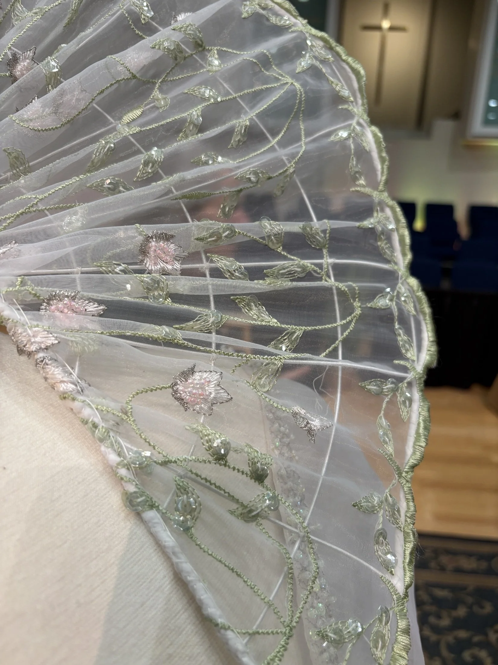 Detail of the dramatic collar with embroidered vines and sparkling accents, enhancing the gown’s whimsical, fairytale aesthetic.