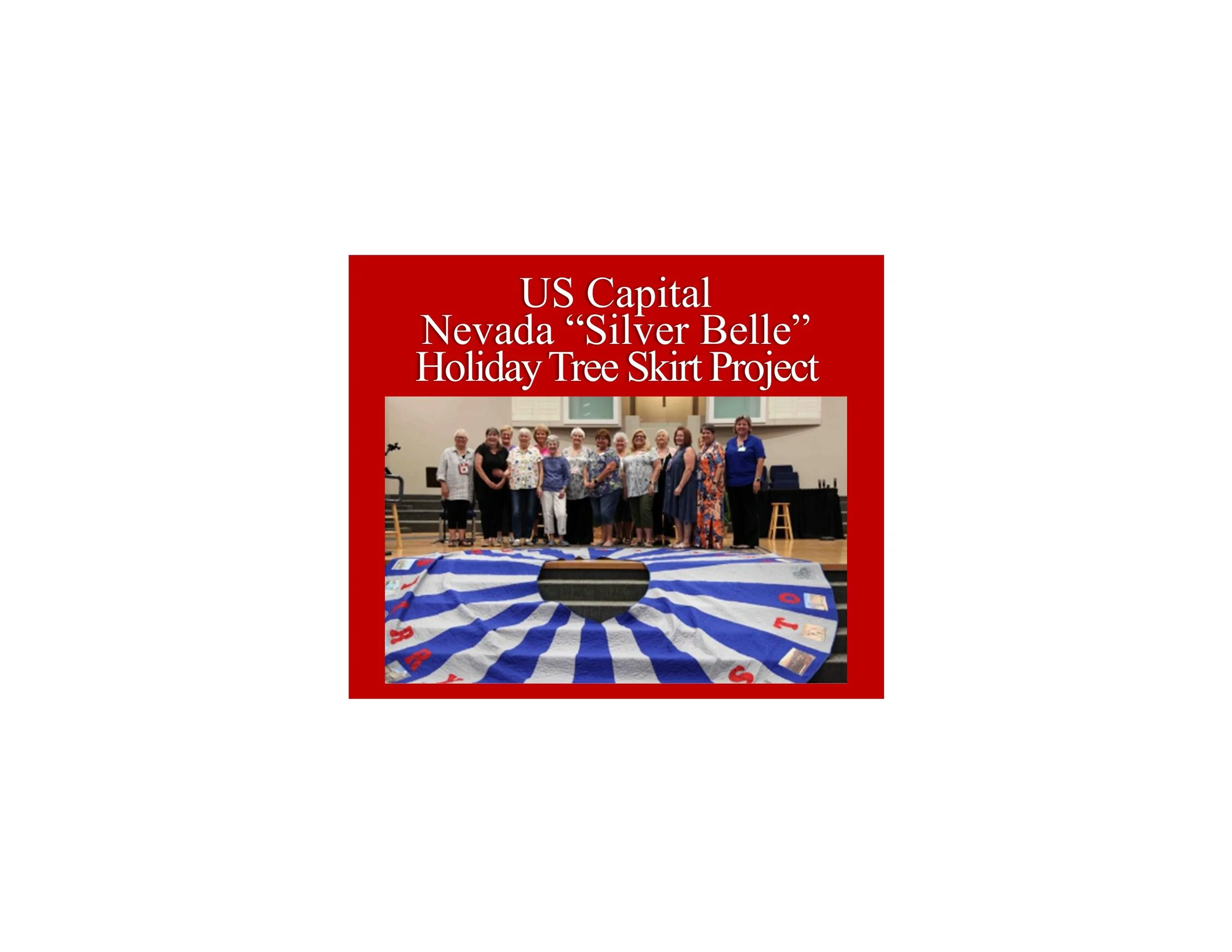 A group of people standing on a stage behind a large, decorated tree skirt with the words "Silver Belle" in a community center or auditorium.