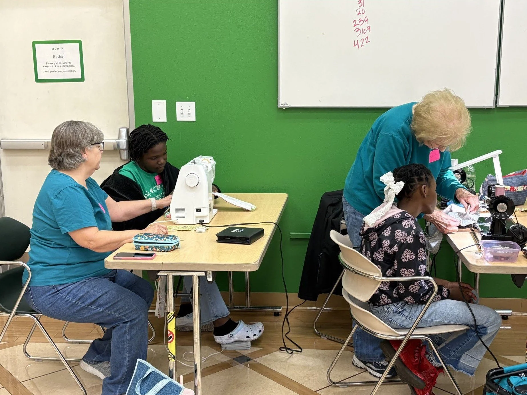 LVQ volunteers provide expert instruction and guidance in the art of sewing to members of the Girl Scouts of Southern Nevada.