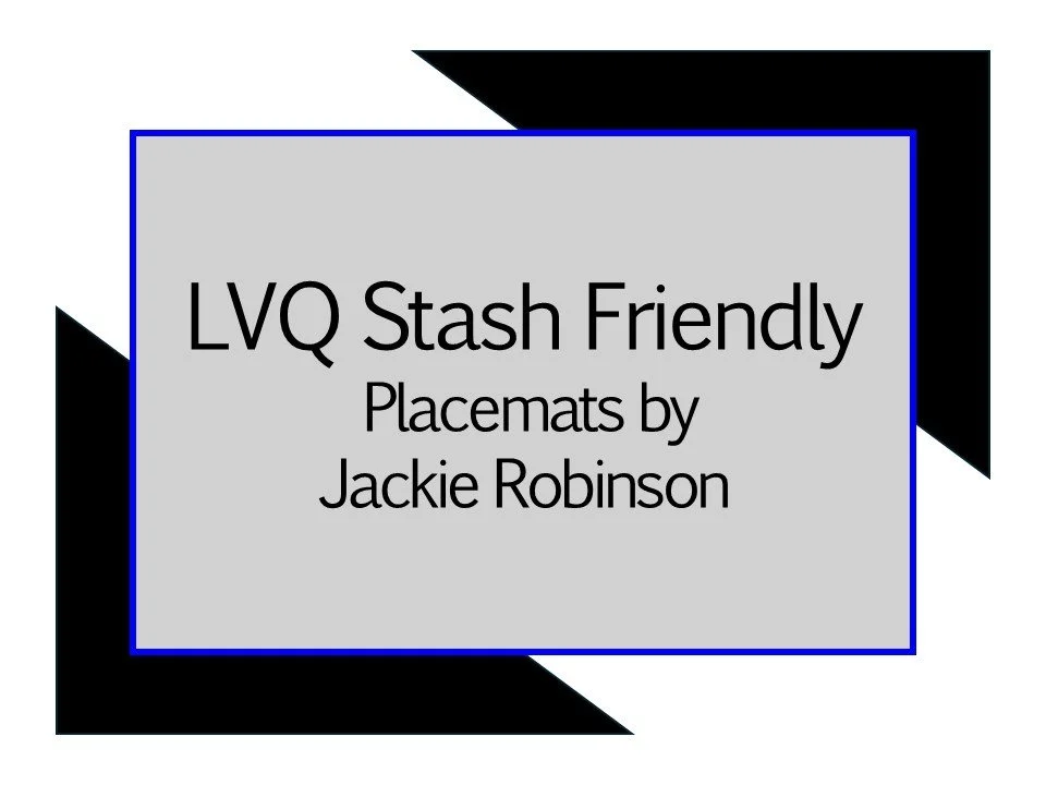 A presentation slide titled 'LVQ Stash Friendly Placemat by Jackie Robinson' with a gray background, black and blue borders, and geometric black shapes in the corners.