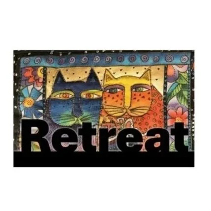 Colorful artwork of two stylized cats, one black-eyed blue and the other orange with spots, with the word "Retreat" in bold black letters below.