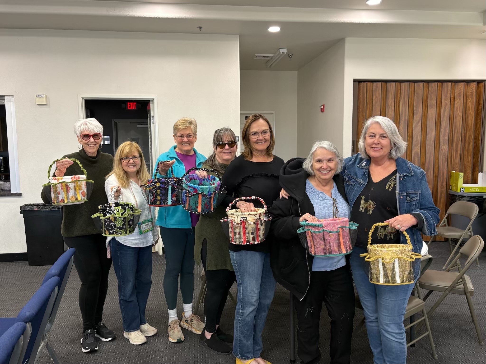 LVQ members who participated in a quilters caddy workshop present their finished project.