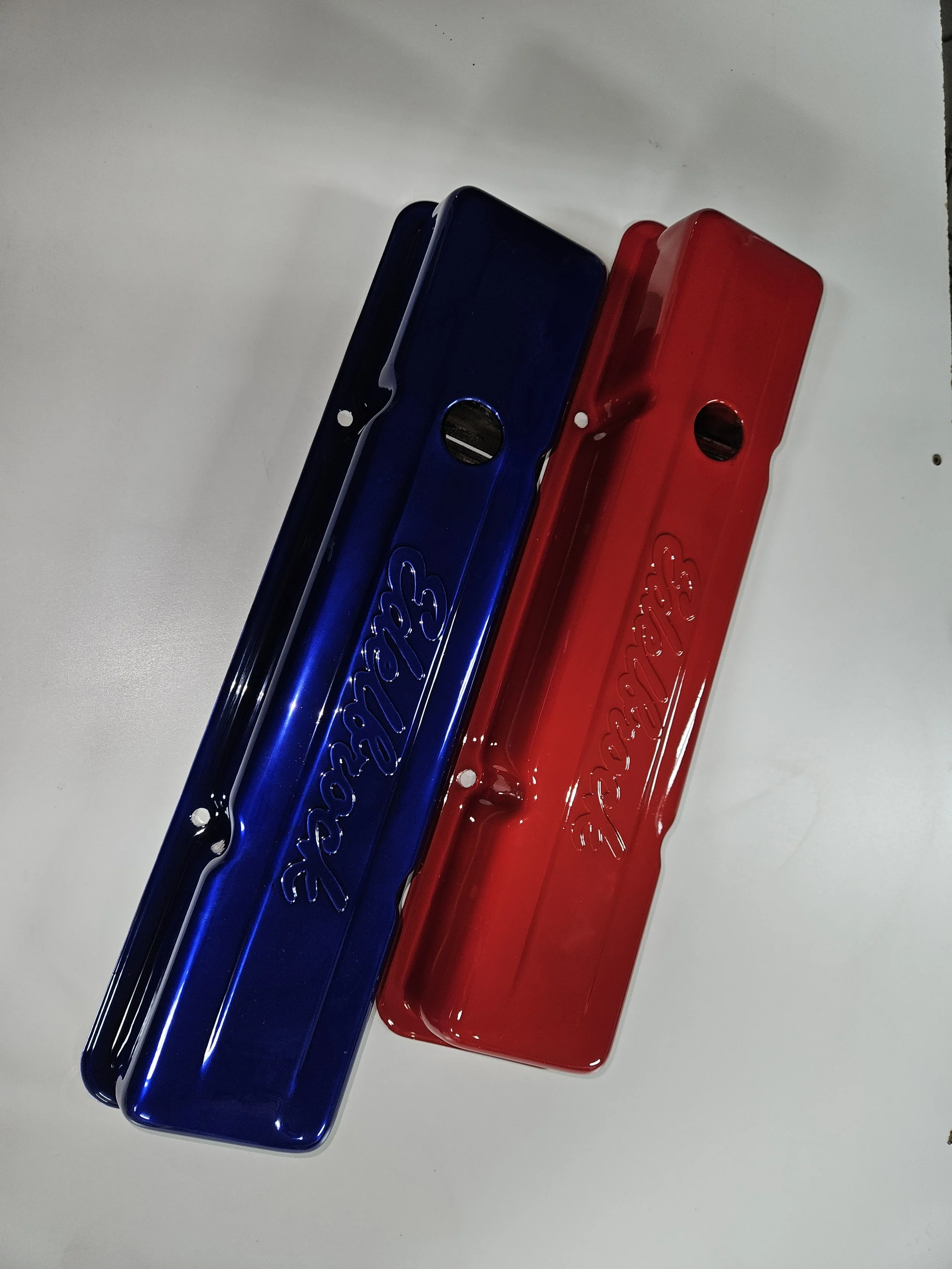 Two metal toolboxes, one blue and one red, with the word 'Snap-on' embossed on the lids, placed on a white surface.