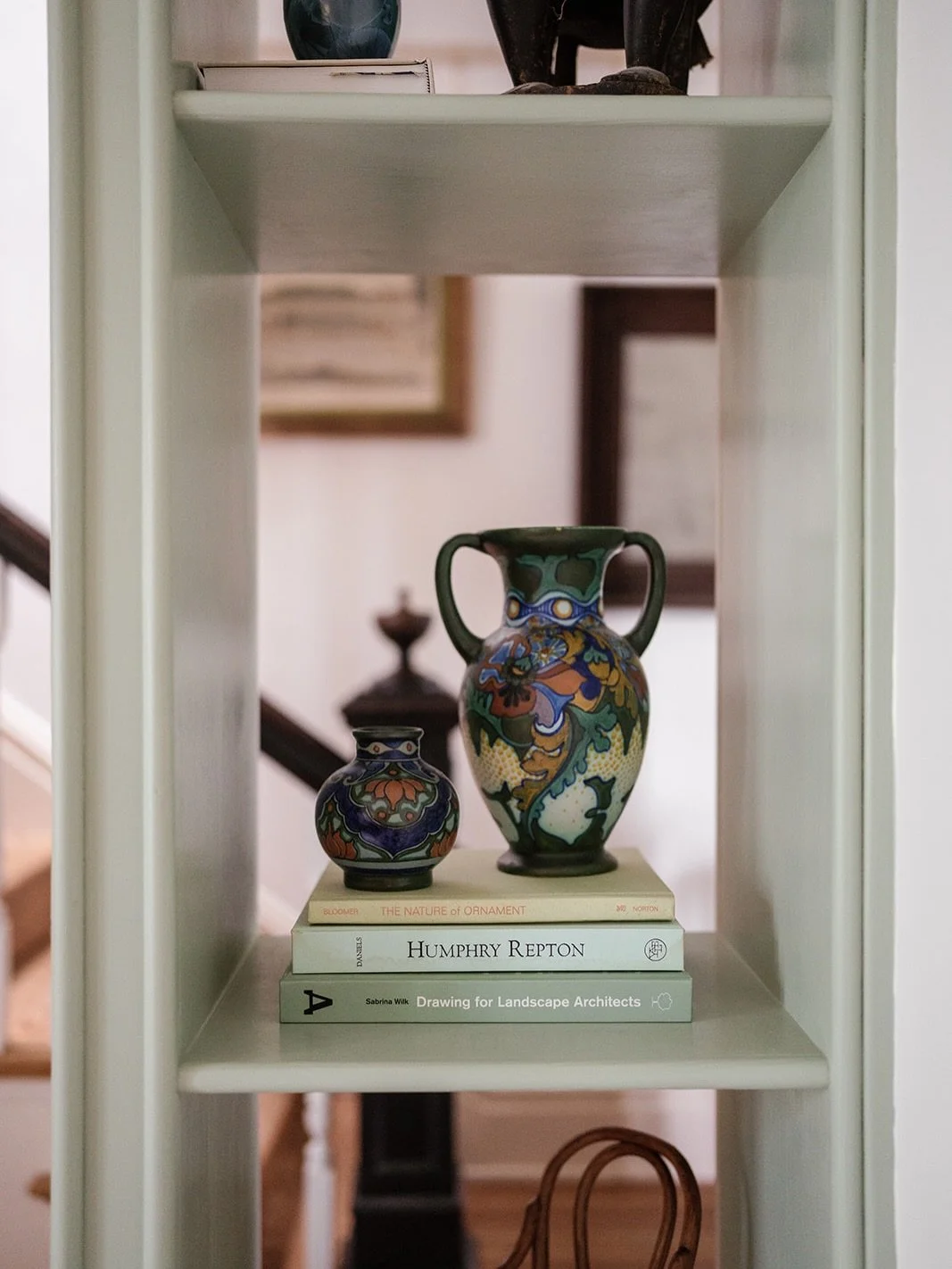 We love when millwork becomes architecture.
⠀⠀⠀⠀⠀⠀⠀⠀⠀
This custom shelving acts as a gentle buffer between spaces &mdash; maintaining transparency while adding depth and layered color. The graduated shelf heights honor collected pieces, and the custo