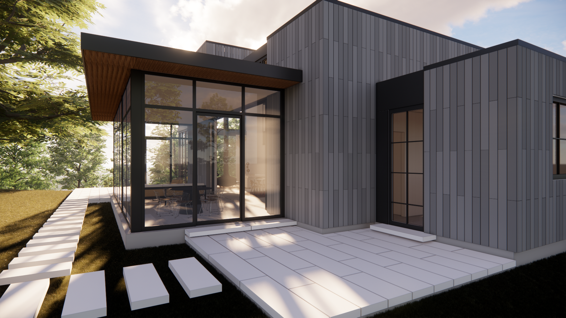 Modern waterfront house in the Northern Neck of Virginia with large glass windows, cement board cladding, and a patio terrace, surrounded by green trees, during sunset.