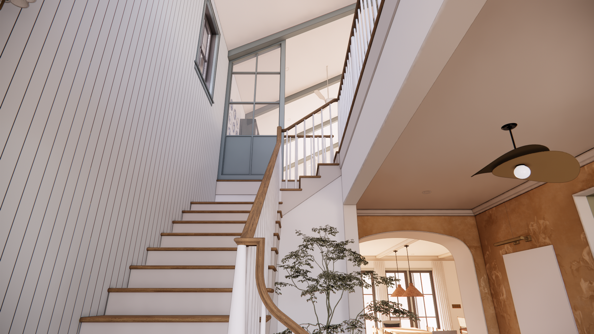 Interior view of a modern staircase with wooden handrails and white balusters. At the top, there's a glass partition and windows allowing natural light. A nearby plant and hanging lights are visible, creating a warm and inviting atmosphere.