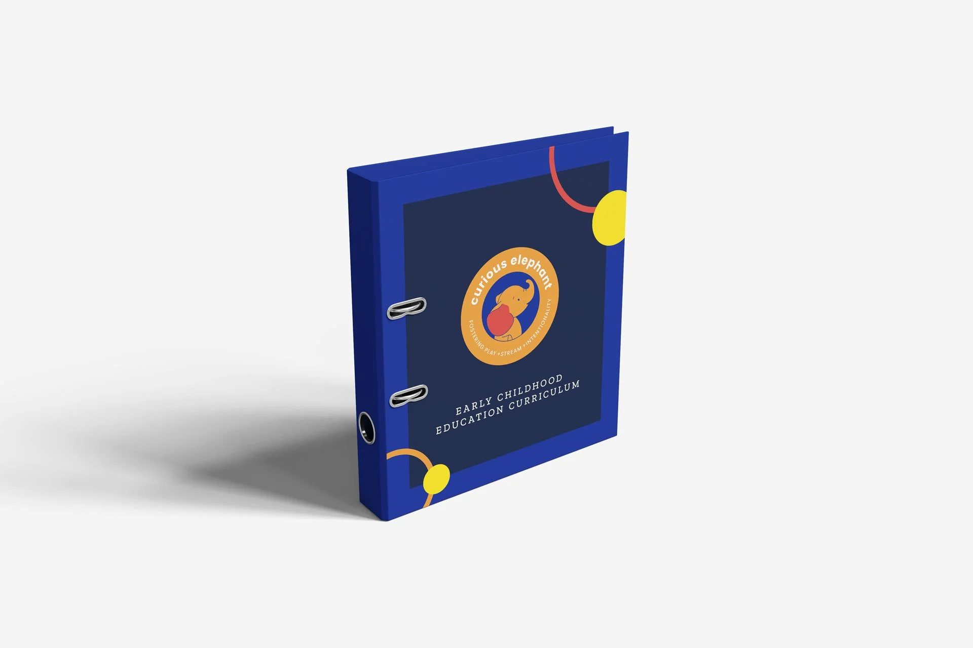 A blue binder with a cover label titled "Early Childhood Education Curriculum" and a logo with a cartoon elephant, marked "Curious Elephant"