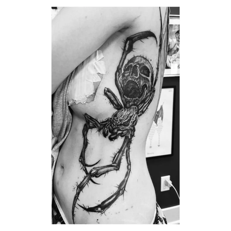Large spider tattoo on woman side in shelton ct