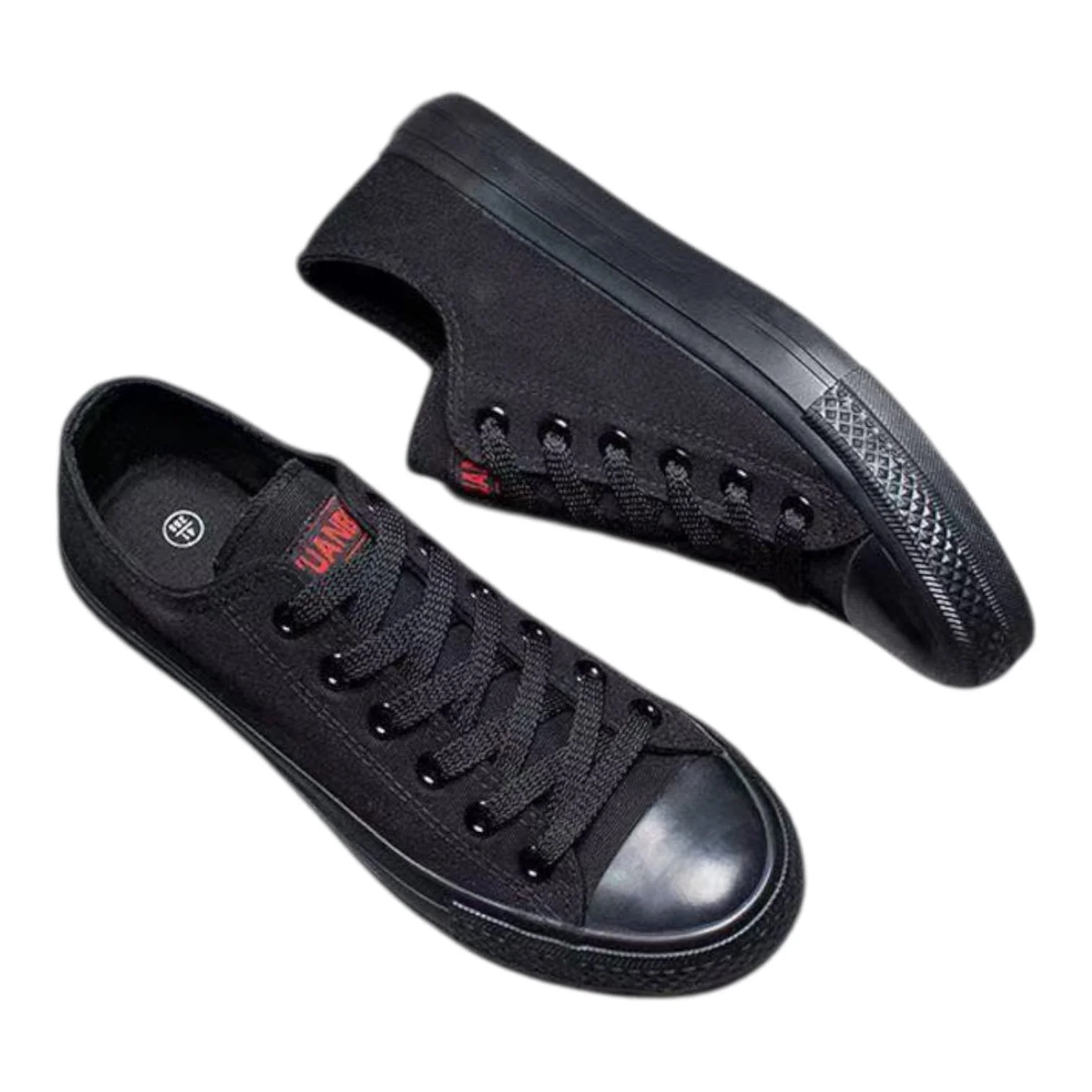 Pair of black canvas sneakers with black rubber soles and toe caps, one shoe showing the logo on the tongue and the other shoe showing the sole details.