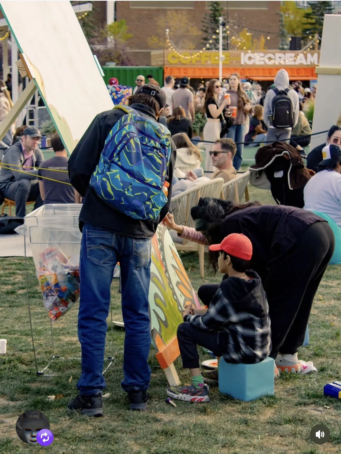 Attendees exploring the activity area at a Dos Leches free outdoor event in Calgary