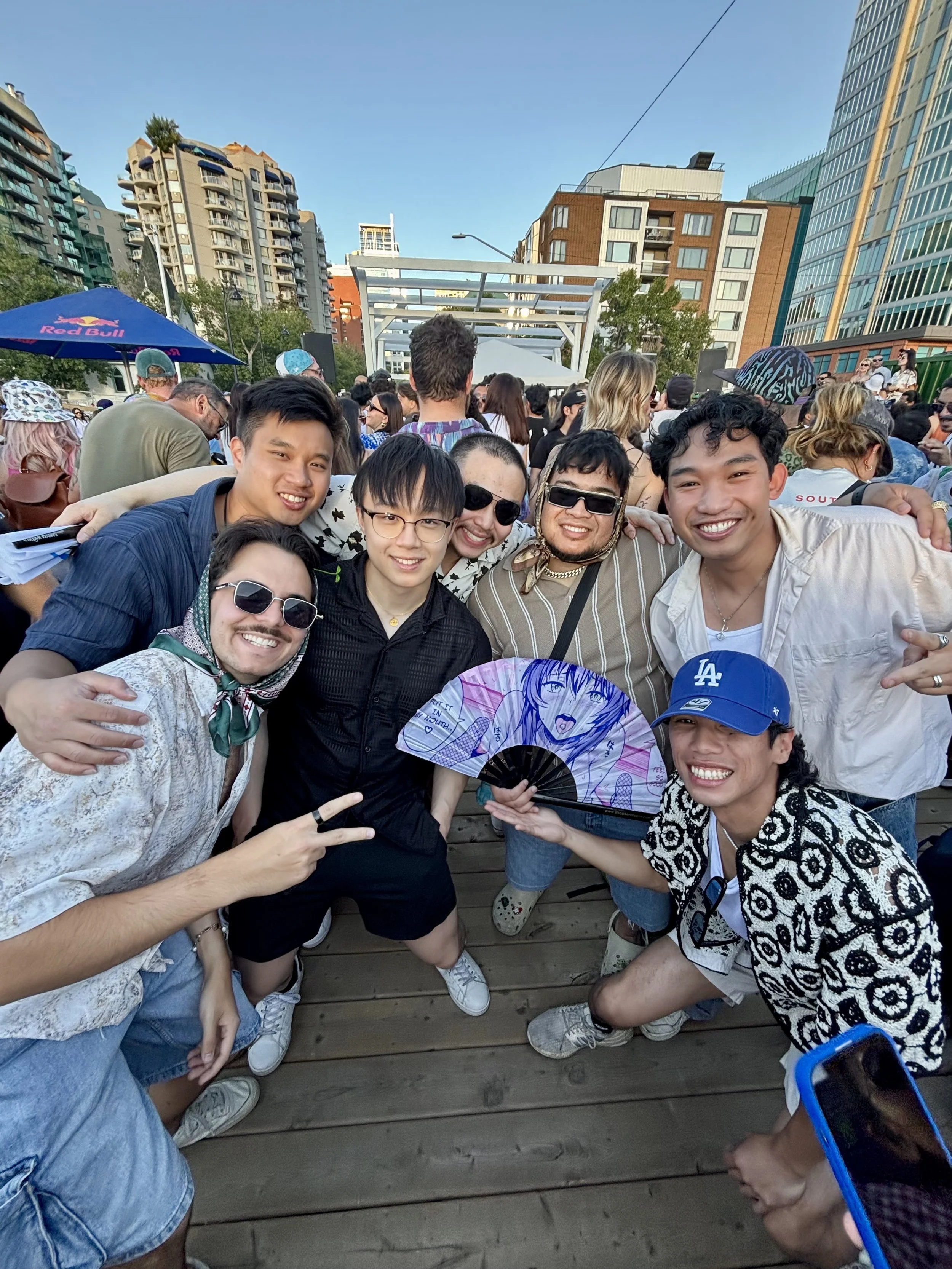 Friends at a Dos Leches event in downtown Calgary with the city skyline behind them