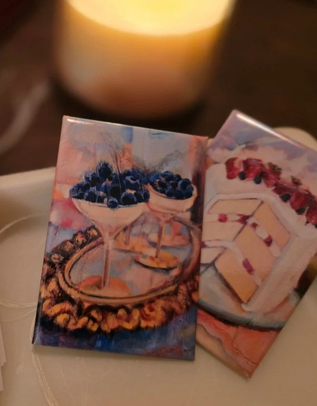 Paintings of desserts including blueberries in glass bowls and slices of cake with berries.