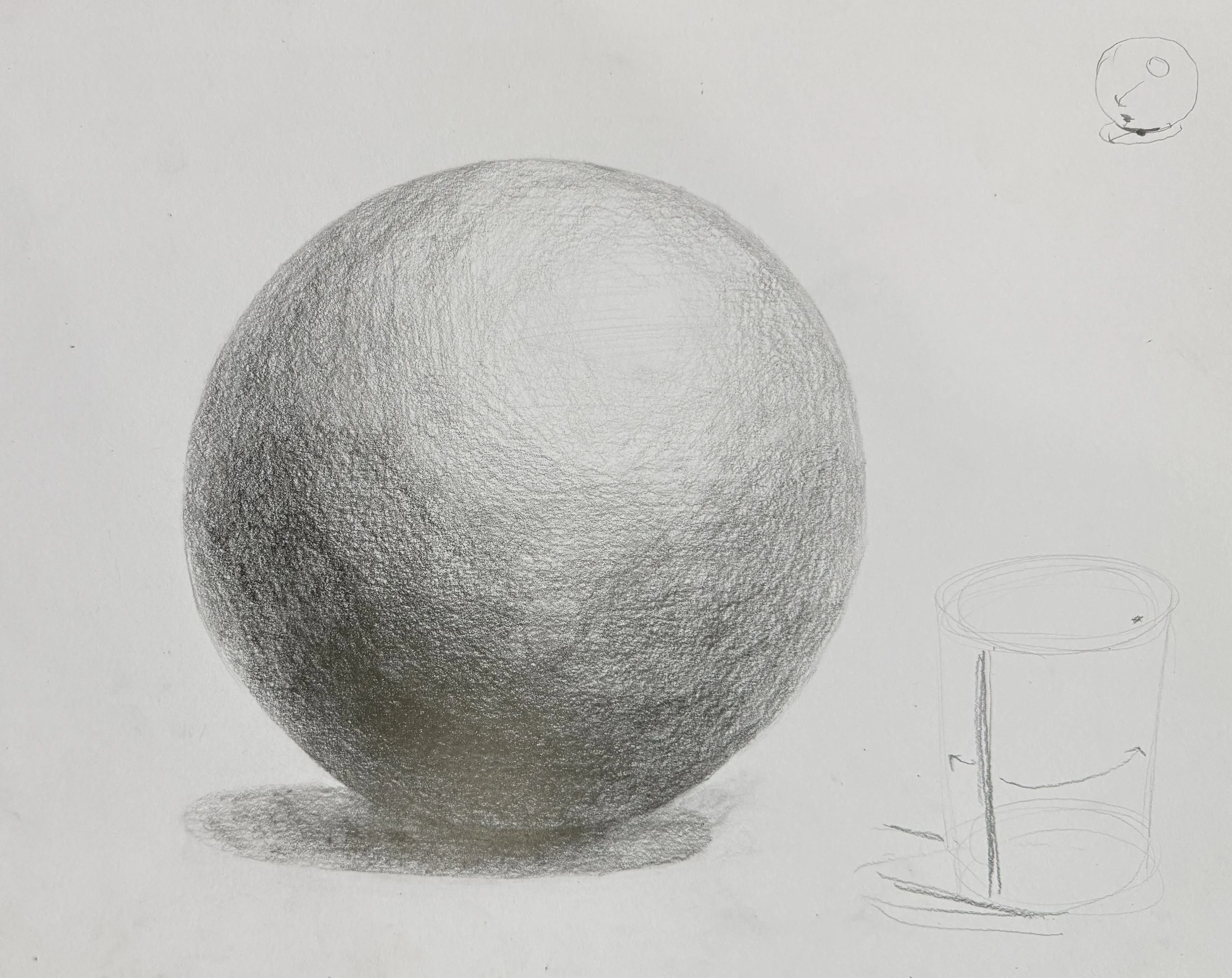 Hand-drawn pencil sketches of a large sphere, a smaller sphere, and a simple drawing of a cup with a straw.