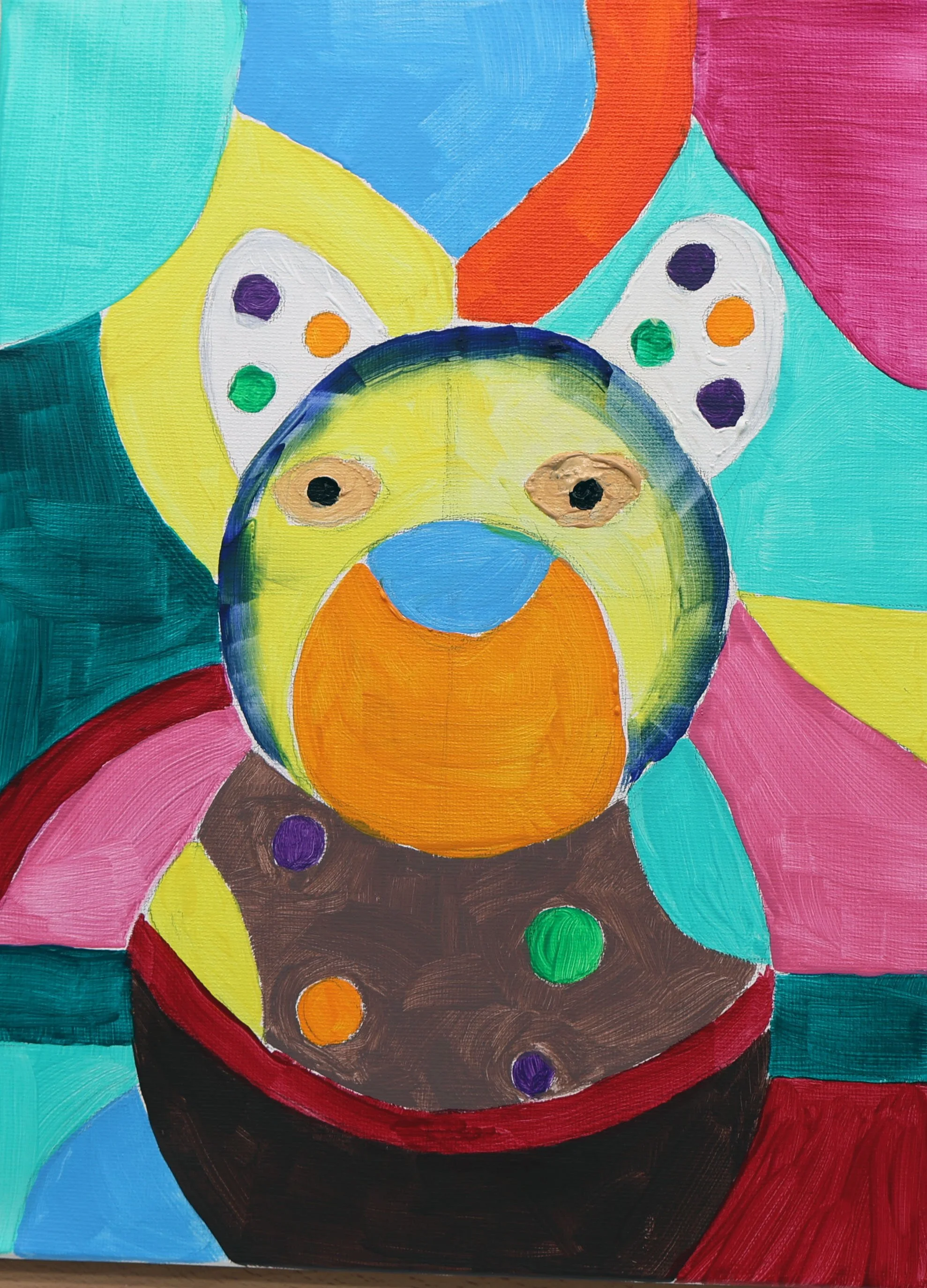 Colorful painting of a dog with butterfly wings, sitting in a pot with colorful dots, surrounded by large, vibrant shapes.