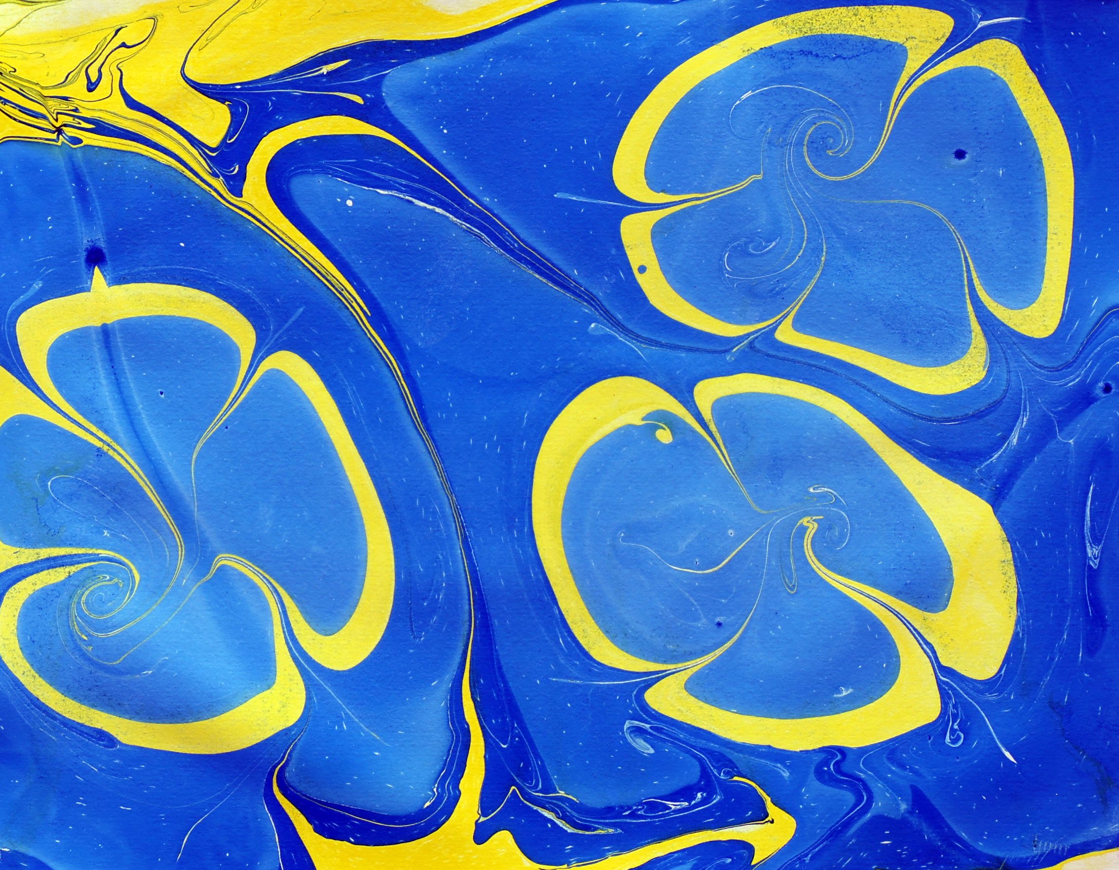 Abstract marbled pattern with blue and yellow swirling colors.