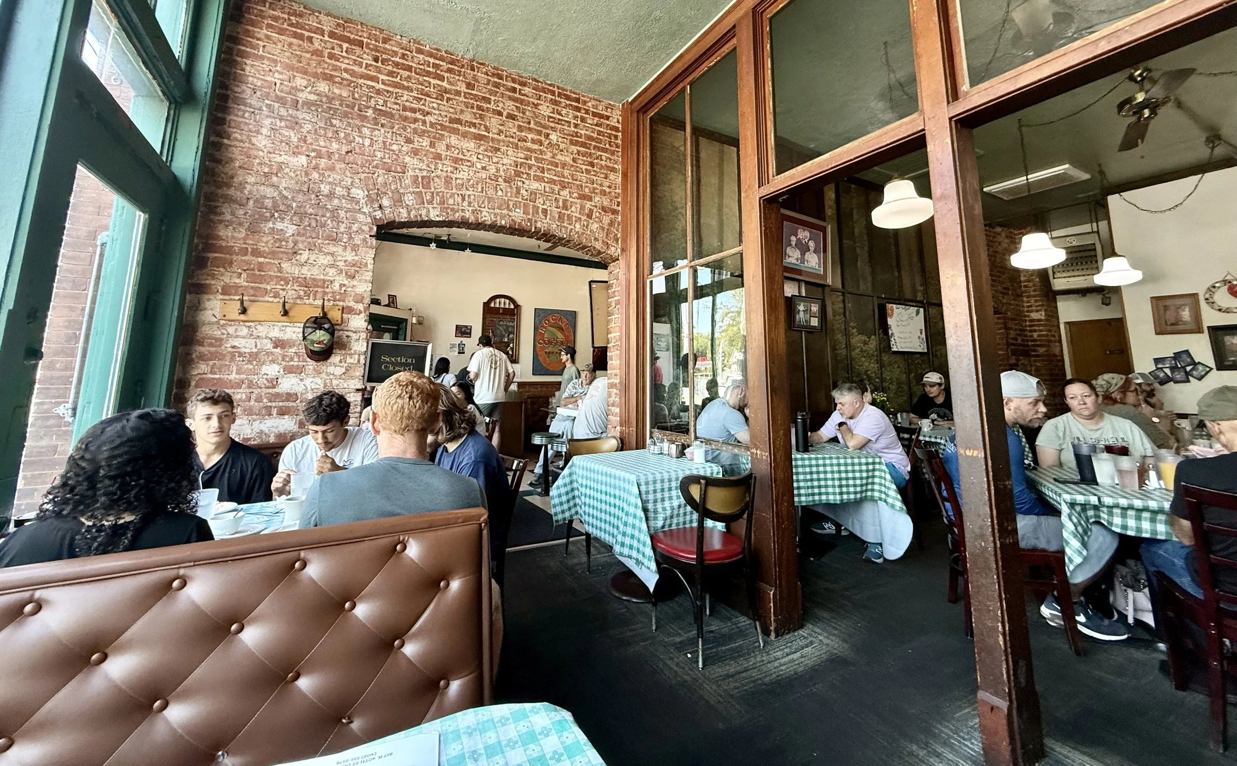 Customers dining in a full restaurant — the behavior underlying customer profiling and store supportability analysis.