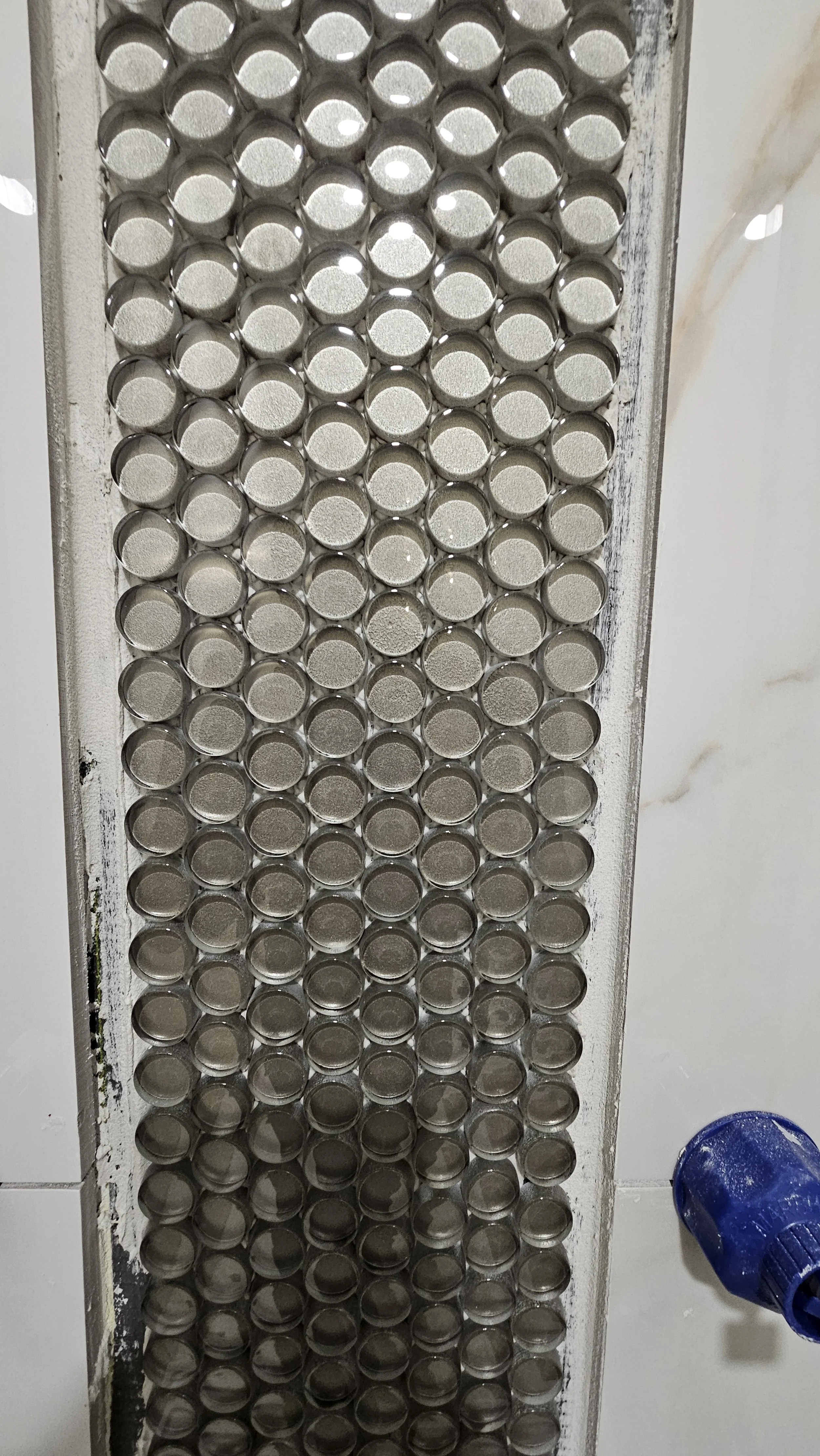 Close-up of a heat sink with metal fins and a blue fan.